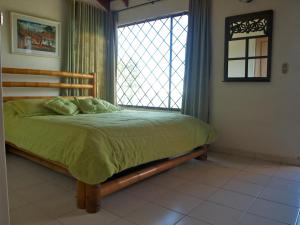 a bedroom with a bed with a large window at Silvania, Ferienhaus - Casa Campestre in Silvania +55 photos