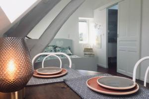 two plates on a table in a living room at TONNERRE grand studio de charme au coeur de la ville in Tonnerre