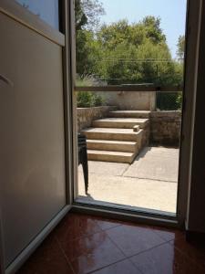 an open door with a view of a stairway at Apartman Aronia in Kotor
