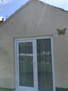 a butterfly on the side of a house with a window at Donegal Court Yard in Chapel Saint Leonards