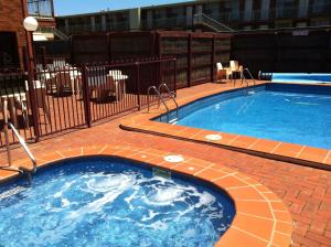 
a pool with a pool table and a tennis racquet at Downtown Motel Warrnambool in Warrnambool
