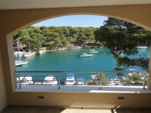 a window with a view of a harbor with boats at Apartment Aurea in Primošten