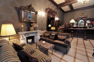 a living room with a couch and a fireplace at Hotel Bursztynowy Pałac in Koszalin