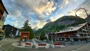 a group of benches in front of a mountain at Studio Omis in Zermatt +5 photos