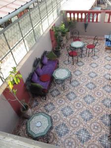 a balcony with tables and chairs on a patio at Sindi Sud in Marrakesh