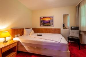 Postel nebo postele na pokoji v ubytování Hotel Neudeck