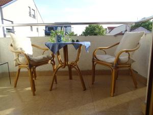 two chairs and a table on a balcony at Blue Apartment in Belgrade