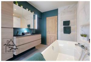 ein Badezimmer mit einer weißen Badewanne und einem Waschbecken in der Unterkunft at Home in Bruges in Brügge