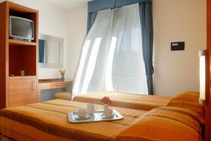 Letto o letti in una camera di Hotel La Tonnara