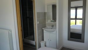 a bathroom with a sink and a mirror at Hotel Castel Moor in Le Croisic