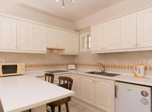 a kitchen with white cabinets and a counter top at Fewo Jacqui in Los Cristianos