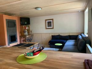 a living room with a couch and a bowl on a table at Gîte Côté Verre in Meisenthal