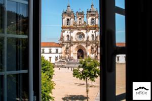 a view from a window of a building with a clock tower at Hostel Rossio Alcobaça in Alcobaça