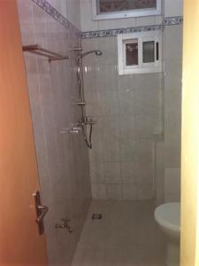 a shower stall in a bathroom with a toilet at Résidence Comara in Marcory