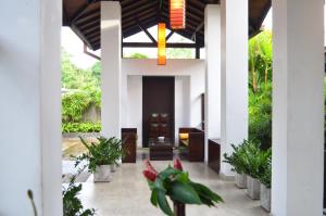 a hallway of a house with plants and a door at Nature Trails Boutique Hotel in Unawatuna