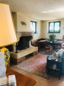 a living room with a fireplace and a table at Domus Cariana in San Pietro in Cariano