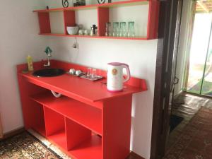 a red cabinet with a sink and a counter at eco house summer garden in Kaji-Say