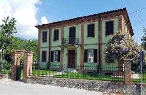 an old house with a fence in front of it at La Fornace in Garessio