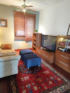 a living room with a flat screen tv and a rug at Villa Torres in Los Llanos de Aridane