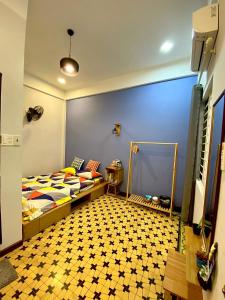 a bedroom with a bed and a tiled floor at Duy Tan Home in Quy Nhon