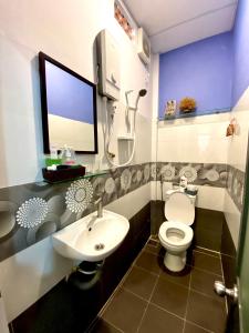 a bathroom with a white toilet and a sink at Duy Tan Home in Quy Nhon
