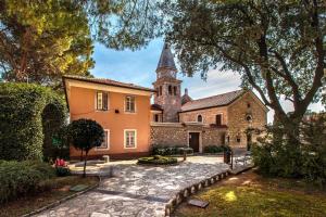 an exterior view of a house with a church at Sweet Cosy Apartment in Matulji
