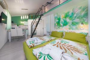 a living room with a green couch and a flower mural at Apartments Miri Vrsar in Vrsar