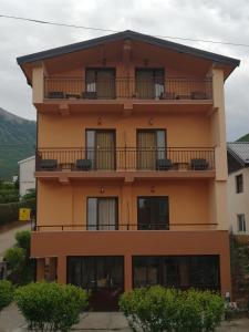 a building with balconies on the side of it at Villa Geros in Trpejca