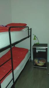 a room with two bunk beds and a night stand at Ca del nono in Pragelato