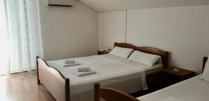 a bedroom with a bed with two towels on it at Vila Jela in Baška Voda