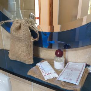 a bathroom counter with a bag and a mirror at romagnoli family cottage in Ameno