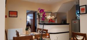 a dining room with a table with flowers on it at Orlando's in Earlham