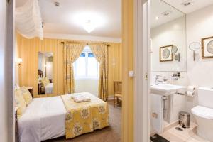 a bedroom with a bed and a sink and a toilet at Casa de Sao Mamede Hotel in Lisbon +88 photos