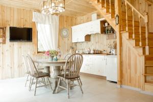 a kitchen and dining room with a table and chairs at Villa Camilla, Затока in Zatoka