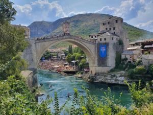 a bridge over a river with a waterfall at Hotel Bristol in Mostar