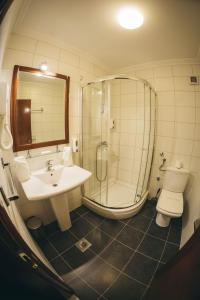 a bathroom with a sink, toilet and bathtub at Hotel Bristol in Mostar