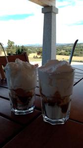 two glasses of ice cream sitting on a table at B&B Andrieddu in Telti +70 photos