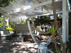 a patio with a hammock under a pergola at Villaggio Camping Oasi in Vieste