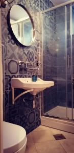 a bathroom with a sink and a toilet and a mirror at Liza's downtown apartment in Hvar