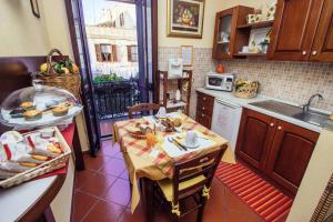een kleine keuken met een tafel en een wastafel bij B&B Antiche Mura in Tarquinia