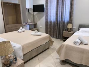 Postel nebo postele na pokoji v ubytování Deni's Hotel