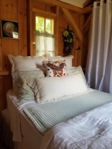 a bed with a teddy bear sitting on top of it at Four Ninety Muskoka B & B in Gravenhurst