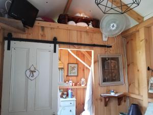 a room with a door in a kitchen with wooden walls at Four Ninety Muskoka B & B in Gravenhurst