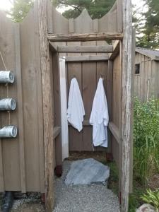 a wooden shed with two white towels hanging on it at Four Ninety Muskoka B & B in Gravenhurst