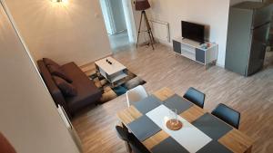 a living room with a table and a couch and a television at En pleine montagne in Mercus-Garrabet