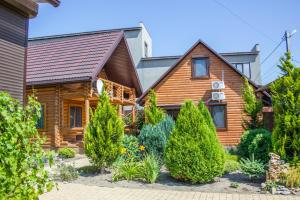 a log home with landscaping in front of it at Villa Camilla, Затока in Zatoka