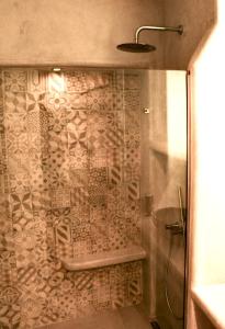 a bathroom with a shower with a glass door at Kounelia Luxury Apartments in Kithnos