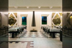 a dining room with tables and chairs on a checkered floor at HD | Duecitânia Design Hotel in Penela