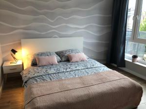 A bed or beds in a room at Apartament Alfa z parkingiem