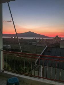 a view of the sunset from the balcony of a building at Agaraj apartament in Orikum